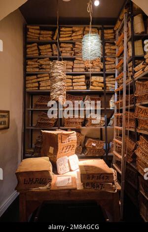 Interior gallery, displaying stacks of old bank ledger, yellowed, sepia record books. At the Museo dell'Archivio Storico del Banco di Napoli, the Bank Stock Photo