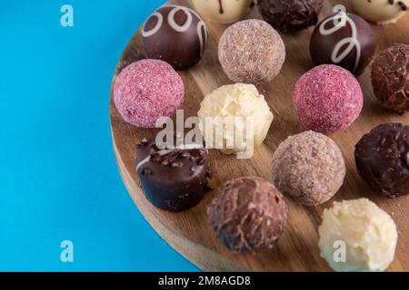 photo of chocolates in chocolate, lying on a wooden board close-up Stock Photo