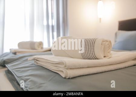 Clean towels on bed in modern interior bedroom Stock Photo