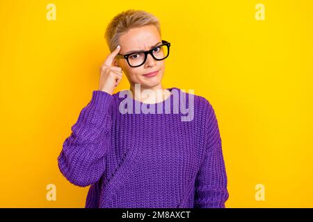 Photo of smart pretty lady wear eyeglasses arm touch head temples offer you think again isolated on yellow color background Stock Photo