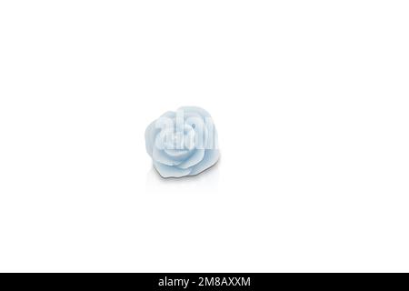 Scented candle of various colors isolated on white background in the shape of a flower. Elegant colored candle Stock Photo