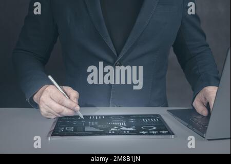 Businessman using tablet analyzing sales data and economic. Businessman with digital tablet on desk. business management using modern digital technolo Stock Photo