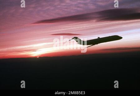 A right side view of a silhouetted C-9C Nightingale aircraft from the 99th Military Airlift Squadron in flight. Country: Unknown Stock Photo