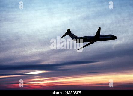 A right side view of a silhouetted C-9C Nightingale aircraft from the 99th Military Airlift Squadron in flight. Country: Unknown Stock Photo