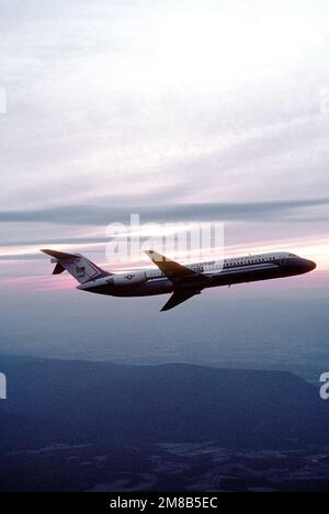 A right side silhouetted view of a C-9C Nightingale aircraft from the 99th Military Airlift Squadron in flight. Country: Unknown Stock Photo