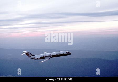 A right side view of a C-9C Nightingale aircraft from the 99th Military Airlift Squadron in flight. Country: Unknown Stock Photo