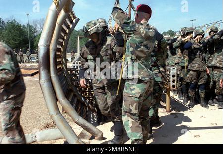 A jump master pulls static lines aside as members of the 82nd Airborne Division make a practice jump from an aircraft mock-up during Exercise SAND EAGLE '89. Subject Operation/Series: SAND EAGLE '89 Base: Saint Mary'S State: Georgia (GA) Country: United States Of America (USA) Stock Photo