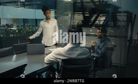 African American businesswoman leader woman female coach business trainer CEO leader boss talking to multiracial business team multiethnic diverse Stock Photo