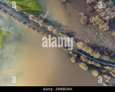 Heuchelheim, Germany. 13th Jan, 2023. A country road near Heuchelheim in Hesse is flooded after days of rainfall (aerial photo taken with a drone). Further rainfall could cause more rivers and streams to burst their banks. Credit: Boris Roessler/dpa/Alamy Live News Stock Photo