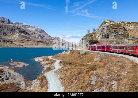 bernina express mountain railway train passing lago bianco Stock Photo