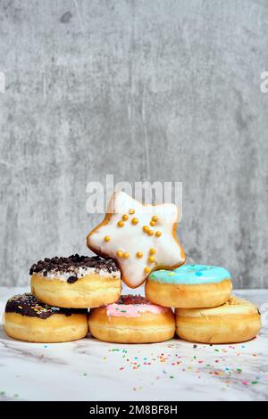 Stack of donuts with sprinkles on a white background Stock Photo - Alamy