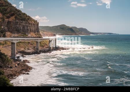 Sea Cliff Bridge, a balanced cantilever bridge built in 2005, curves around the coast of New South Wales in Australia connecting the towns of Clifton Stock Photo