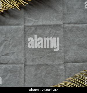 Frame of tropical green leaf with gray fabric background. top view, copy space Stock Photo