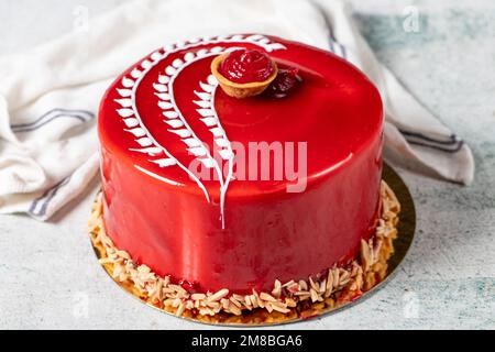 Raspberry cake. Celebration or birthday cake covered with raspberry on the outside and filled with forest fruits. Special design. close up Stock Photo
