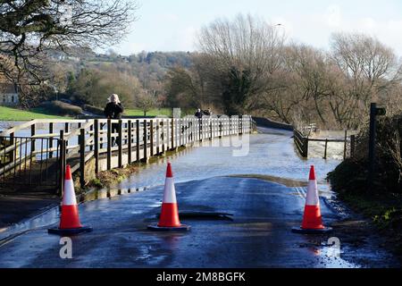 Traffic cones block a bridge flooded by the River Avon, in Lacock, Wiltshire. Picture date: Friday January 13, 2023. Stock Photo