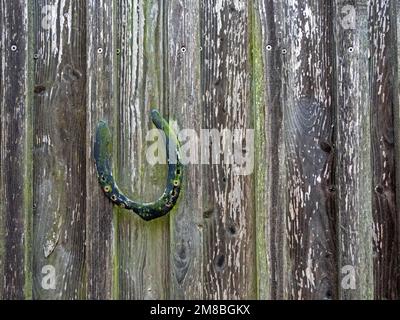 Horseshoe as a symbol of luck on an old wooden wall Stock Photo