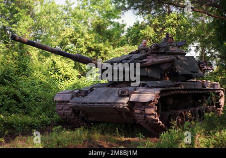 Marine Corps Base. A tank crew from 2nd Tank Battalion, 2nd Marine Division, sits aboard their M-60A1 tank as they wait to move on to the next objective during the joint services Exercise Solid Shield '89. The tank is fitted with reactive armor. Subject Operation/Series: SOLID SHIELD '89 Base: Marine Corps Base, Camp Lejeune State: North Carolina (NC) Country: United States Of America (USA) Stock Photo