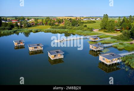 “Etang du Stock”, pond flowing into the Canal des Houilleres de la Sarre, Moselle. Little houses on the pond, huts on stilts, unusual housing, holiday Stock Photo