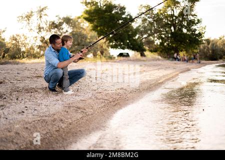 Dad and Son Go Fishing Together, Stand in the Water with Fishing