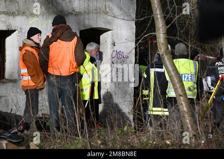 Erkelenz, Germany. 13th Jan, 2023. Dirk Weinspach (M), police chief of Aachen, comes out of a building on the third day of the eviction in the lignite village of Lützerath occupied by climate activists. Activists are said to have barricaded themselves in a tunnel here. The energy company RWE wants to excavate the coal lying under Lützerath - for this purpose, the hamlet on the territory of the city of Erkelenz at the opencast lignite mine Garzweiler II is to be demolished. Credit: Federico Gambarini/dpa/Alamy Live News Stock Photo