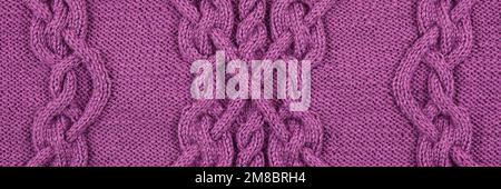 Knitted lilac background. Large knitted fabric with a pattern. Close-up of a knitted blanket. Horizontal ornament. Banner Stock Photo