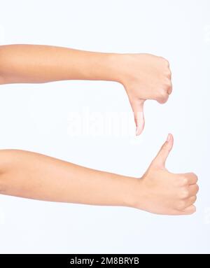 Hands, thumbs up and thumbs down in yes or no gesture for vote, poll or social media likes on white background. Sign language, finger or hand sign in Stock Photo