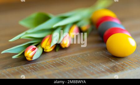 Easter greeting card with eggs and tulips Stock Photo