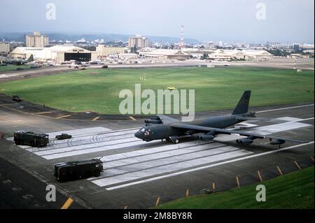 Two Air Force P-2R aircraft firefighting and rescue trucks sit at the end of the runway in front of a 43rd Bombardment Wing B-52G Stratofortress aircraft. The trucks were dispatched when the aircraft's brakes overheated during landing, but no fire occurred. The aircraft flew to Yokota from Anderson Air Force Base, Guam, for the annual Japanese-American Friendship Festival. Subject Operation/Series: JAPANESE-AMERICAN FRIENDSHP FESTIVAL Base: Yokota Air Base Country: Japan (JPN) Stock Photo