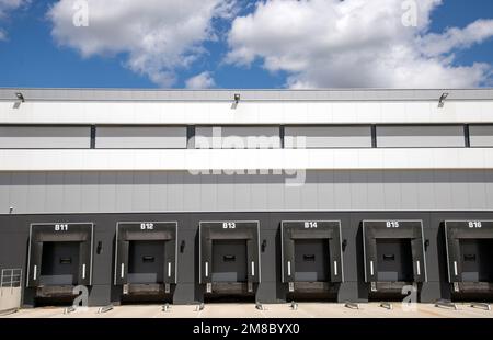 A row of loading docks with shutter doors at a warehouse Stock Photo