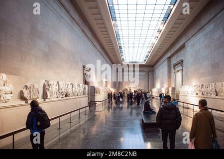 Visitors view the Parthenon Marbles, also known as the Elgin Marbles, at the British Museum in London on January 12, 2023. - The ancient sculptures we Stock Photo