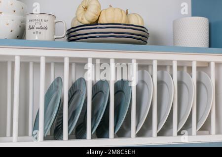 a plates in a shelf in the kitchen Stock Photo