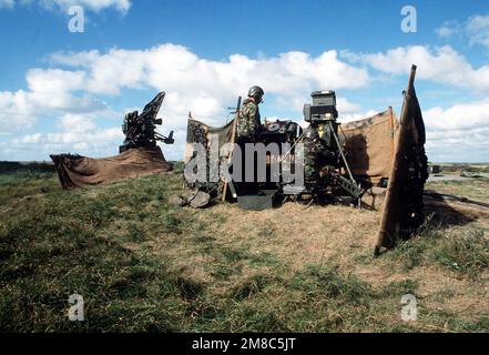 Two members of 19 Squadron, Royal Air Force (RAF) Regiment, a British air defense unit, man a radar site at Oksboel firing during the NATO exercise Tactical Fighter Weaponry '89. Subject Operation/Series: TACTICAL FIGHTER WEAPONRY '89 Country: Denmark (DNK) Stock Photo