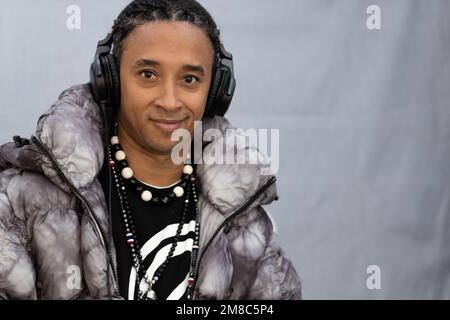 DJ at music party posing and smiling at camera Stock Photo