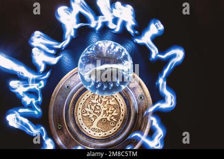 Lensball illuminated with light painting, the tree of life symbol under the lensball Stock Photo
