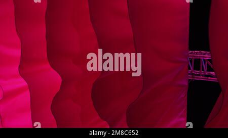 Light flowing red fabric imitating waves. The concept of lightness, female beauty, tenderness. Air show. Association with women's critical days Stock Photo