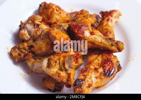 Fried chicken legs for dinner on white plate background close up. Stock Photo