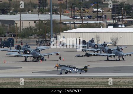 040306-F-3745E-025. A World War II (WW II) era P-51 Mustang pursuit (fighter) aircraft (foreground) taxis on the flight line in front of five parked US Air Force (USAF) A-10A Thunderbolt II “Warthog” attack aircraft during the Heritage Conference being held at Davis-Montham Air Force Base (AFB), Arizona (AZ). Stock Photo