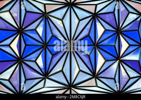 Geometric stained glass architectural detail in blue tones. Faceted skylight composed of triangles. Stock Photo