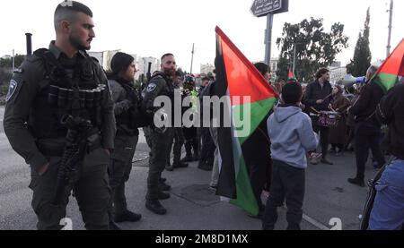 JERUSALEM, ISRAEL - JANUARY 13: Members of the Israeli security force watch over as Israeli left-wing activists and Palestinians holding Palestinian flags take part in a demonstration against Israeli occupation and settlement activity in the Sheikh Jarrah neighborhood on January 13, 2023, in Jerusalem, Israel. Israel's national security minister Itamar Ben-Gvir has ordered police to ban Palestinian flags from public places. Credit: Eddie Gerald/Alamy Live News Stock Photo