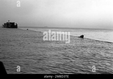 A bulk fuel line to the beach is played out from a spool fitted on the deck of the utility landing craft LCU-1666 during the combined South Korean/U.S. exercise Team Spirit '90. Subject Operation/Series: TEAM SPIRIT '90 Country: Republic Of Korea (KOR) Stock Photo