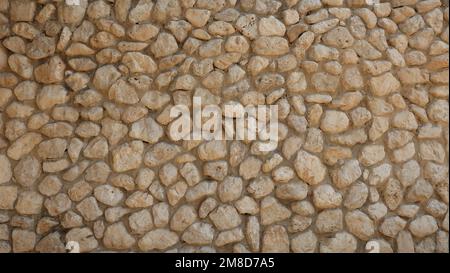 Pebble in concrete Wall. Stone background.  Stone paving surface. Natural outdoor decor material rounded cobbles Stock Photo