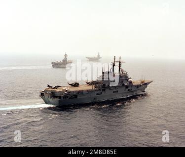 A starboard bow view of the Italian light aircraft carrier ITS GIUSEPPE GARIBALDI (C-551) underway during the NATO Southern Region exercise DRAGON HAMMER '90. Underway in the background are the Spanish aircraft carrier SPS PRINCIPE DE ASTURIAS (R-11), left, and the nuclear-powered aircraft carrier USS DWIGHT D. EISENHOWER (CVN 69). Subject Operation/Series: DRAGON HAMMER '90 Country: Mediterranean Sea (MED) Stock Photo