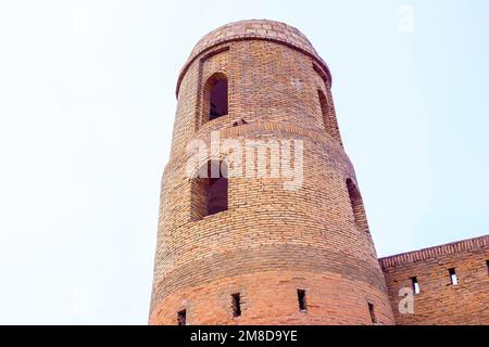 HISOR, TAJIKISTAN - JULY 31, 2022: Ancient Hissar fortress tower exterior in summer against the blue sky. Stock Photo