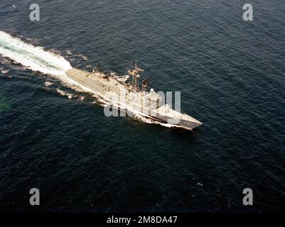 A aerial starboard bow view of the guided missile frigate USS RENTZ (FFG 46) underway. Country: Unknown Stock Photo