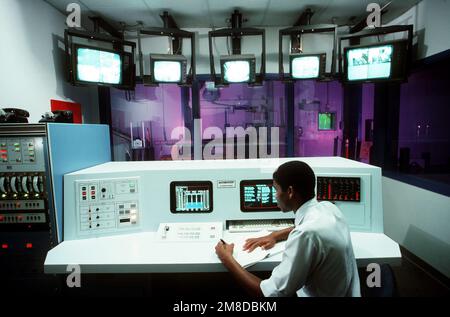Jim Crump, a civilian technician, records some data from one of the monitors in the reactor control room. Base: Mcclellan Air Force Base State: California (CA) Country: United States Of America (USA) Stock Photo