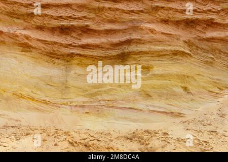 sand layers structure. sedimentary rock-sandstone. Surface of wall. industrial quarry. opencast mining. Stock Photo