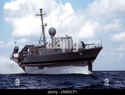 A starboard bow view of the hydrofoil patrol combatant missile ship USS TAURUS (PHM 3), foil-borne. Navy hydrofoils are regularly used on Joint Task Force 4 drug interdiction missions. Country: Unknown Stock Photo