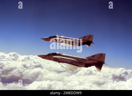 A left side view of two RF-4C Phantom II aircraft of Marine PHOTO Reconnaissance Squadron Three (VMFP-3) in flight over the Marine Corps Air Station. Base: Marine Corps Air Station El Toro State: California (CA) Country: United States Of America (USA) Stock Photo