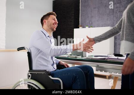Business Person In Wheel Chair Shaking hands Stock Photo