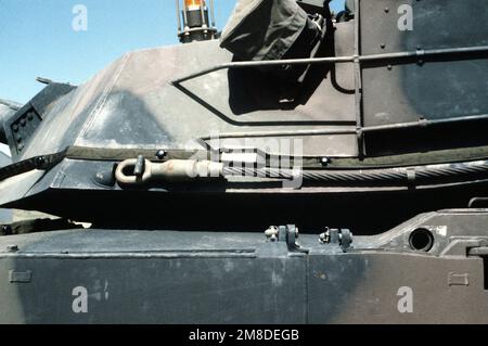 A close-up view of a portion of the left side of the turret on an M-1 Abrams main battle tank. Wrapped around the lower part of the turret is a detector belt for a multiple integrated laser engagement system (MILES). On top of the turret is a hit indicator light, also part of the MILES kit. Base: Fort Carson State: Colorado (CO) Country: United States Of America (USA) Stock Photo